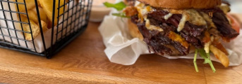PULLED BEEF BURGER - trhané hovädzie mäso, cheddar, údený syr, chipotle majonéza, chrumkavá slaninka, rukola, paradajka, cibuľka, u-hranolčeky